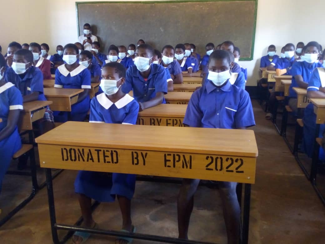 Learners sitting on new desks